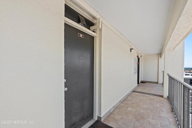 1301 1st St S Unit 1507, Jacksonville Beach, FL 32250 - view of exterior entry featuring a balcony and stucco siding
