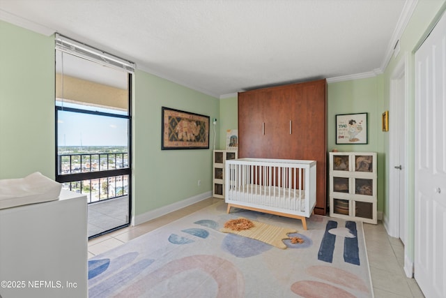 1301 1st St S Unit 1507, Jacksonville Beach, FL 32250 - bedroom with tile patterned floors, baseboards, ornamental molding, and access to exterior