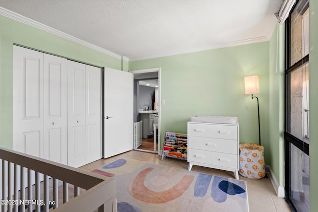 1301 1st St S Unit 1507, Jacksonville Beach, FL 32250 - bedroom with ornamental molding, light tile patterned flooring, a closet, baseboards, and a textured ceiling