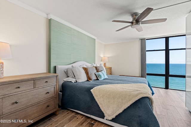 1301 1st St S Unit 1507, Jacksonville Beach, FL 32250 - bedroom featuring a wall of windows, crown molding, a water view, and light wood finished floors