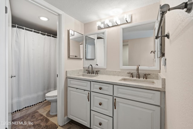 1301 1st St S Unit 1507, Jacksonville Beach, FL 32250 - full bath featuring toilet, a sink, double vanity, and a textured ceiling
