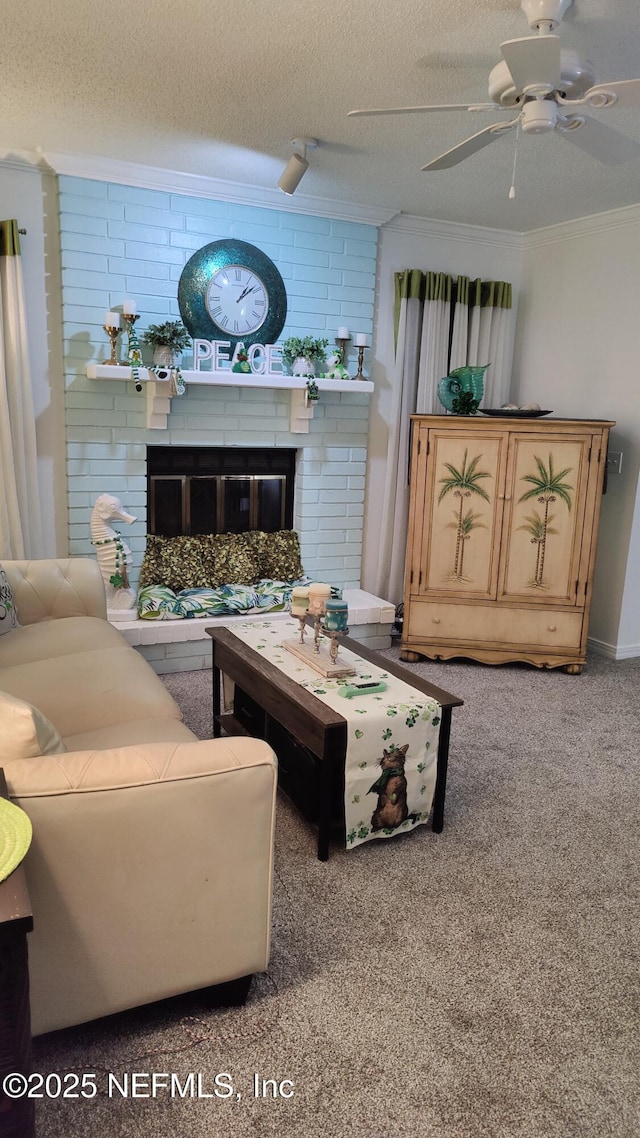 living room with crown molding, ceiling fan, a fireplace, a textured ceiling, and carpet