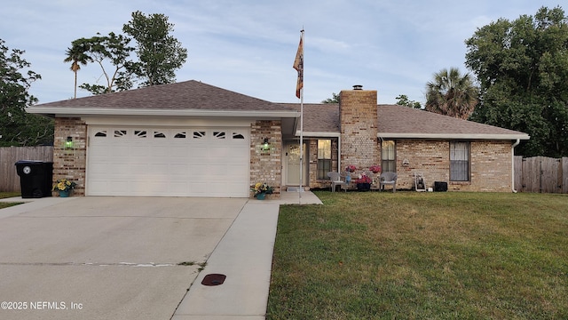 ranch-style house featuring fence, a front yard, a chimney, an attached garage, and driveway