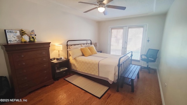 bedroom featuring baseboards, ceiling fan, and wood finished floors