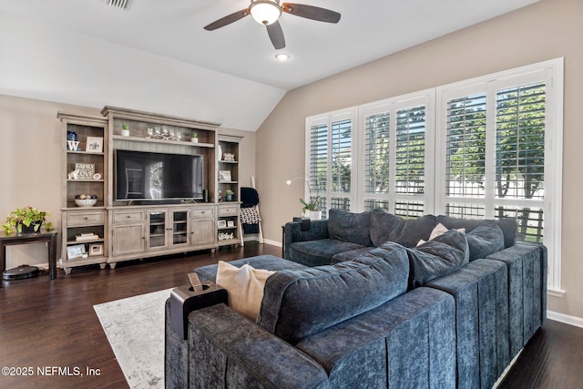 living area with vaulted ceiling, a ceiling fan, baseboards, dark wood-type flooring, and visible vents