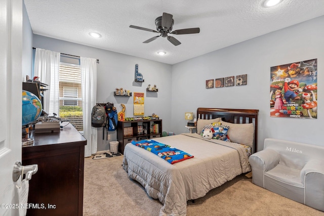 bedroom featuring recessed lighting, a textured ceiling, light colored carpet, and ceiling fan