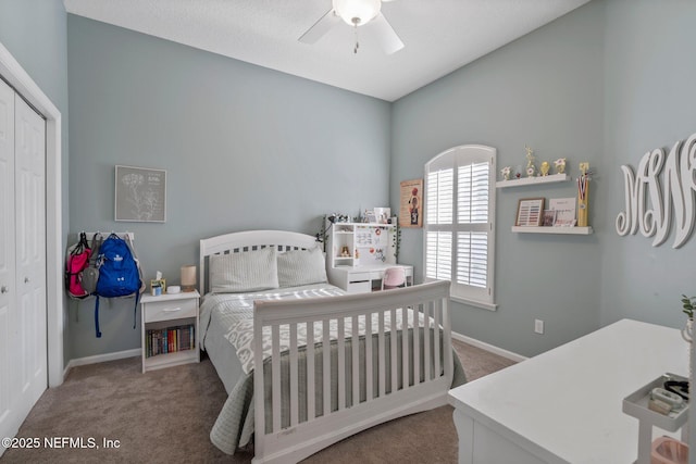 carpeted bedroom with baseboards, a ceiling fan, and a closet