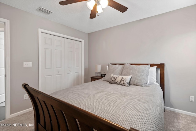 carpeted bedroom featuring baseboards, a ceiling fan, visible vents, and a closet