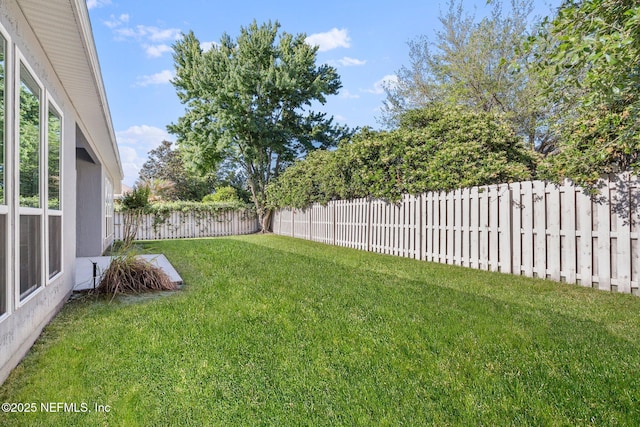 view of yard with a fenced backyard