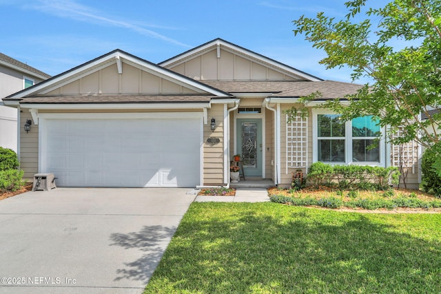 ranch-style home with driveway, board and batten siding, an attached garage, a front yard, and roof with shingles