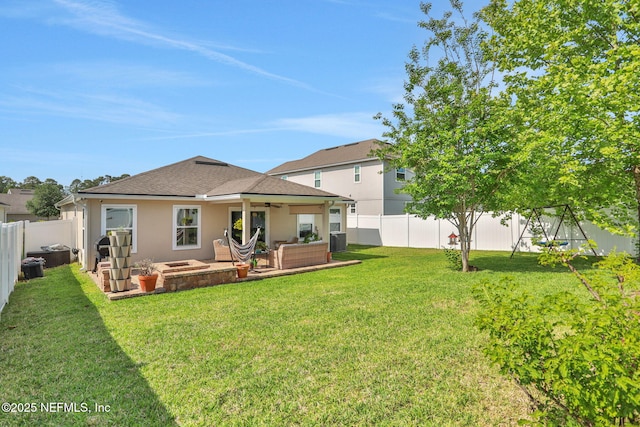 rear view of property featuring a fenced backyard, an outdoor living space, ceiling fan, and a lawn