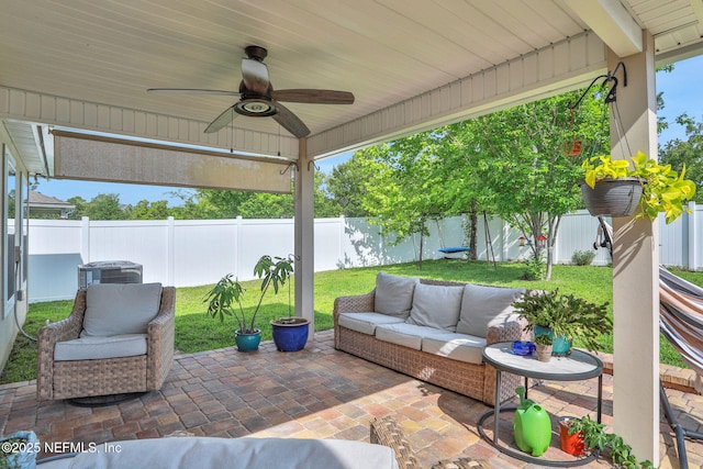 view of patio with outdoor lounge area, a fenced backyard, and ceiling fan