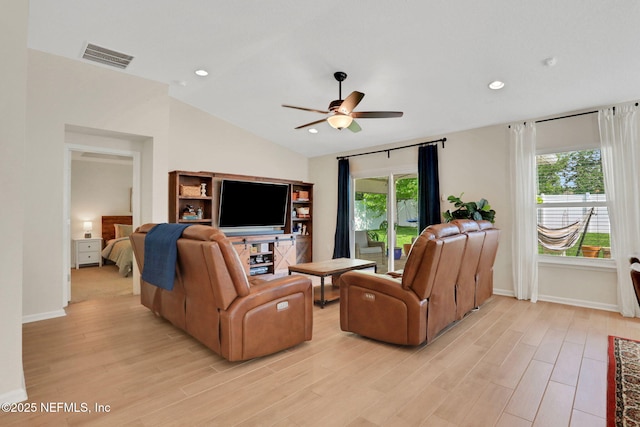 living room with vaulted ceiling, visible vents, light wood-style floors, baseboards, and ceiling fan