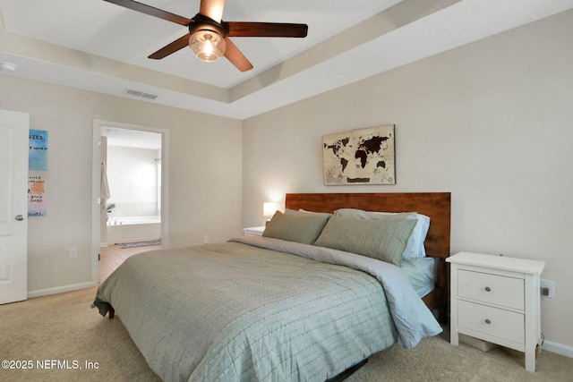 bedroom featuring light colored carpet, baseboards, connected bathroom, and visible vents