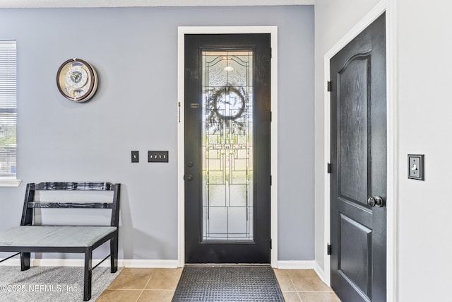 foyer with baseboards and light tile patterned floors