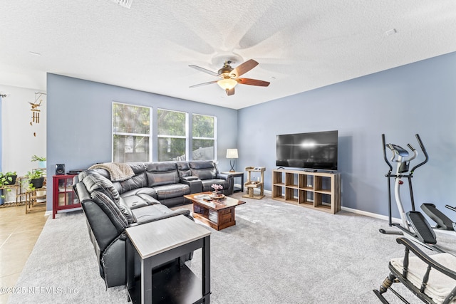 living area featuring a textured ceiling and a ceiling fan