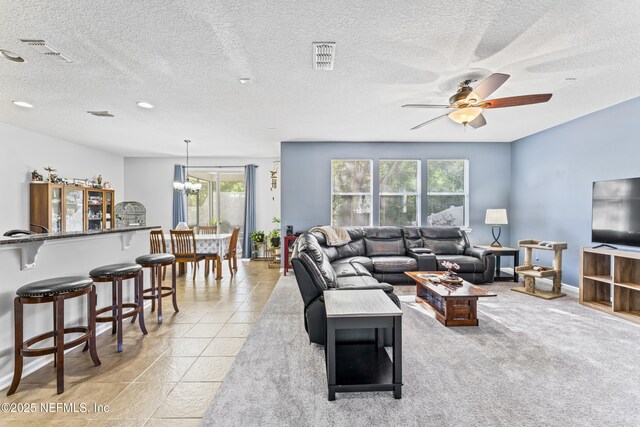 living room featuring plenty of natural light, visible vents, and ceiling fan