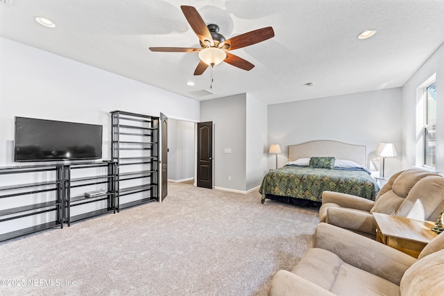 carpeted bedroom with baseboards, visible vents, a textured ceiling, and recessed lighting