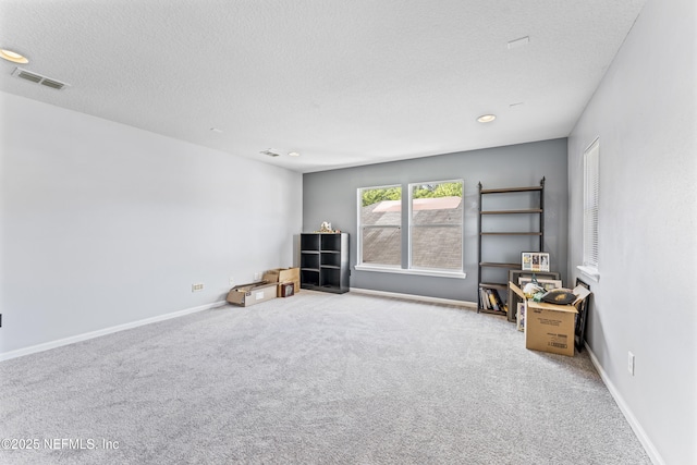 interior space with recessed lighting, a textured ceiling, visible vents, and baseboards