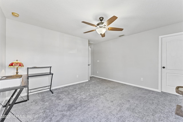 interior space with baseboards, visible vents, a textured ceiling, and ceiling fan