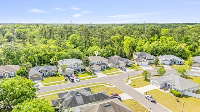 aerial view featuring a residential view and a wooded view
