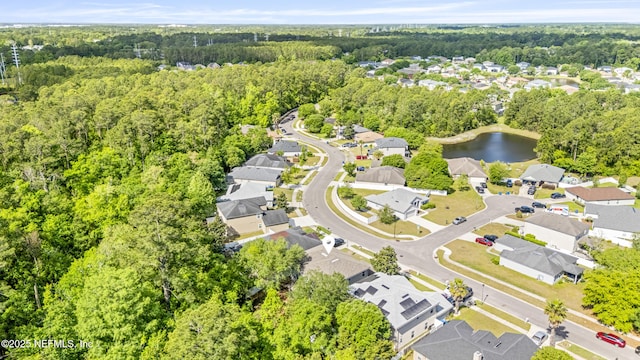 bird's eye view with a view of trees, a residential view, and a water view