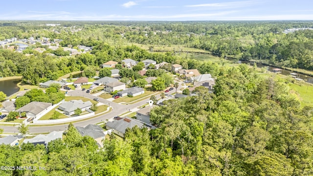 birds eye view of property featuring a view of trees, a residential view, and a water view