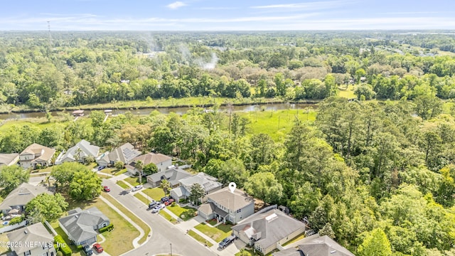 birds eye view of property featuring a residential view, a view of trees, and a water view