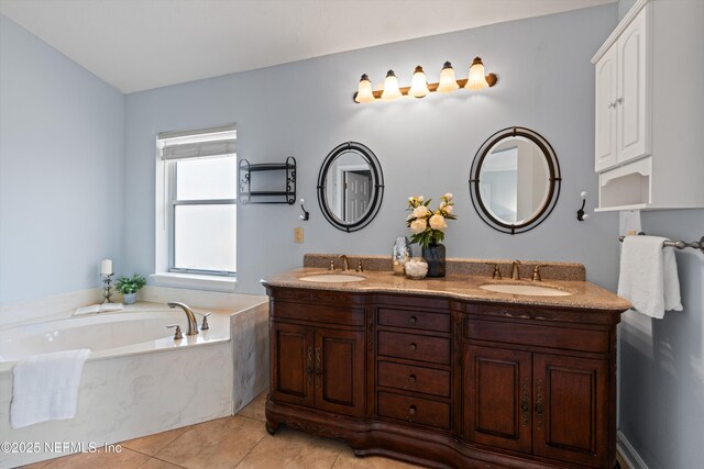 full bath featuring a sink, tile patterned floors, double vanity, and a bath