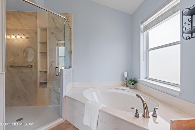 bathroom featuring a garden tub and a marble finish shower