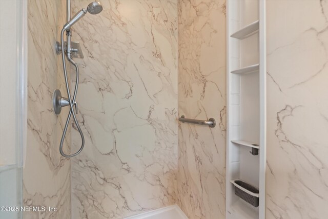 full bathroom featuring a marble finish shower