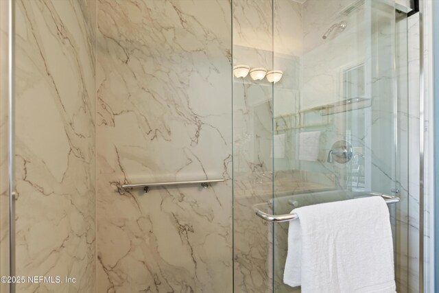 bathroom with a marble finish shower