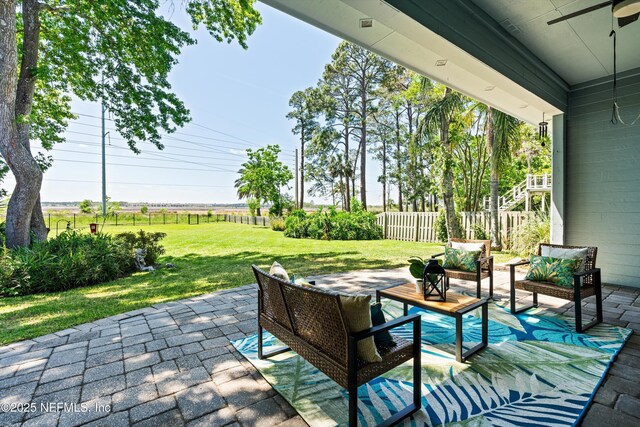 view of patio with fence, an outdoor hangout area, and ceiling fan