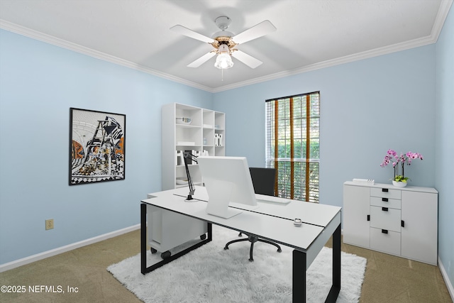 carpeted home office with crown molding, baseboards, and ceiling fan