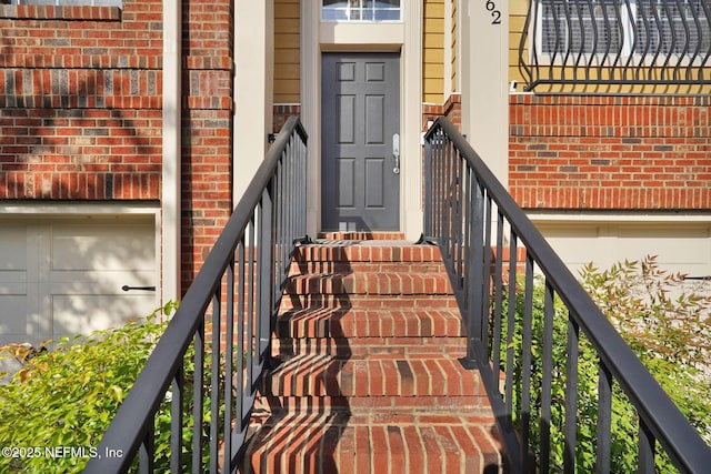 view of exterior entry featuring brick siding