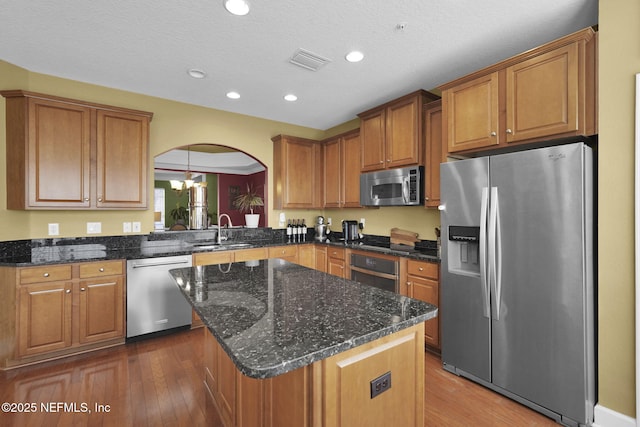 kitchen featuring brown cabinets, recessed lighting, visible vents, a sink, and appliances with stainless steel finishes