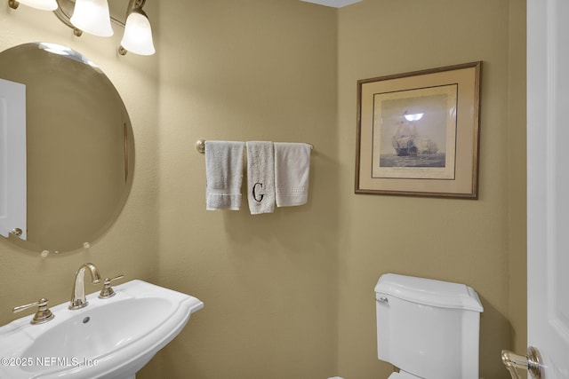 half bathroom with toilet and a sink