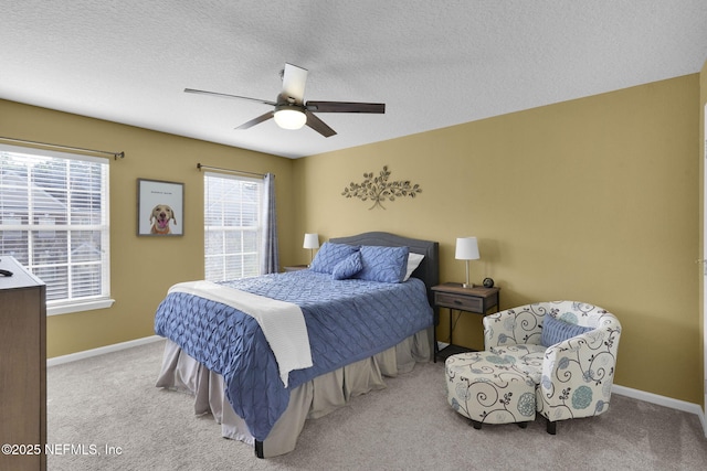 bedroom with a ceiling fan, baseboards, and carpet floors