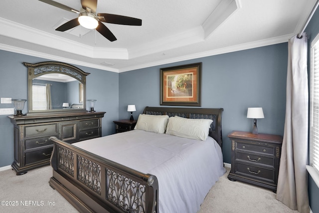 bedroom featuring a raised ceiling, crown molding, a ceiling fan, and light carpet