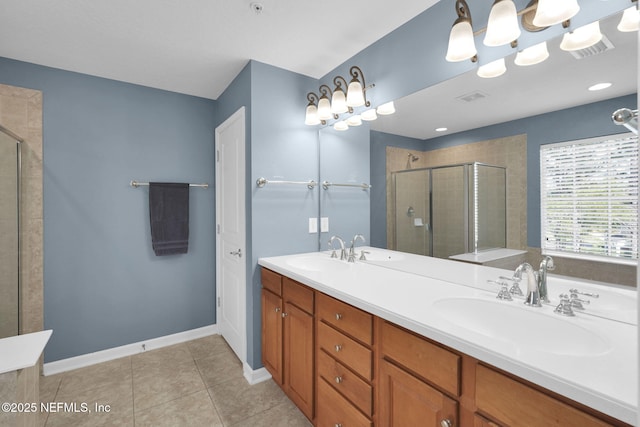 full bathroom featuring baseboards, a sink, double vanity, and a stall shower