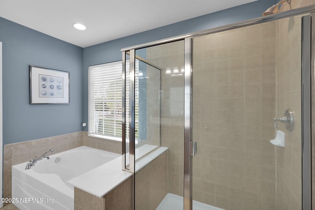bathroom featuring a bath, recessed lighting, and a stall shower