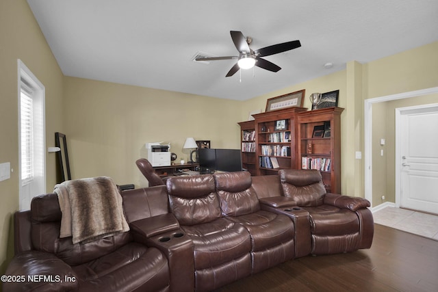 home theater room featuring a ceiling fan and wood finished floors