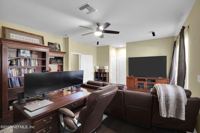 office featuring wood finished floors, a ceiling fan, and visible vents