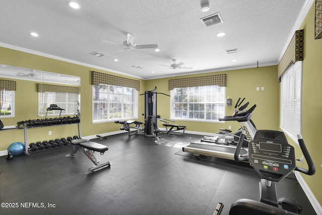 exercise room with a textured ceiling, crown molding, baseboards, and ceiling fan