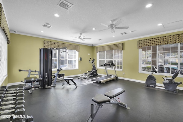 workout area with baseboards, crown molding, and visible vents