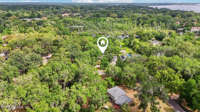 bird's eye view featuring a water view and a wooded view