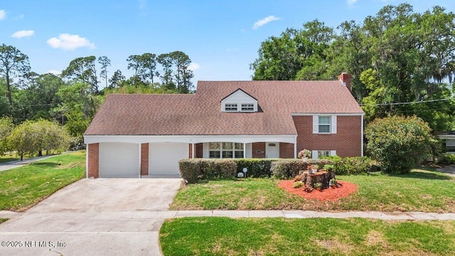 view of front of house featuring an attached garage, brick siding, a front yard, a chimney, and driveway