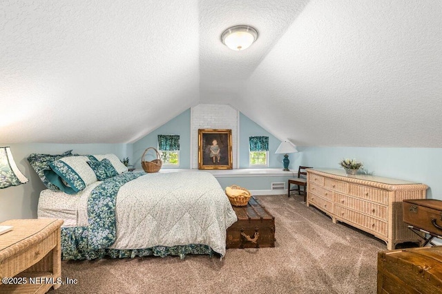 bedroom with visible vents, carpet, a textured ceiling, and lofted ceiling