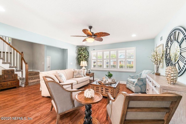 living area featuring ceiling fan, visible vents, stairs, wood finished floors, and recessed lighting