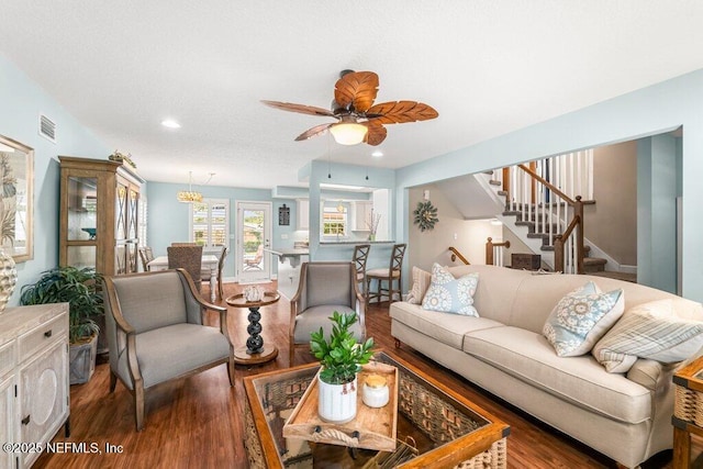 living area with ceiling fan, recessed lighting, wood finished floors, visible vents, and stairway
